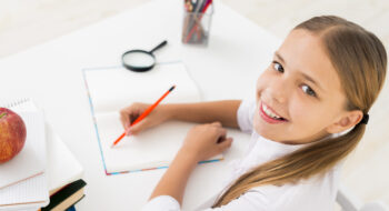 smart-schoolgirl-writing-copybook